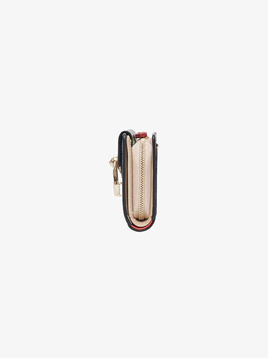 Small beige handbag with a gold clasp on a light gray background